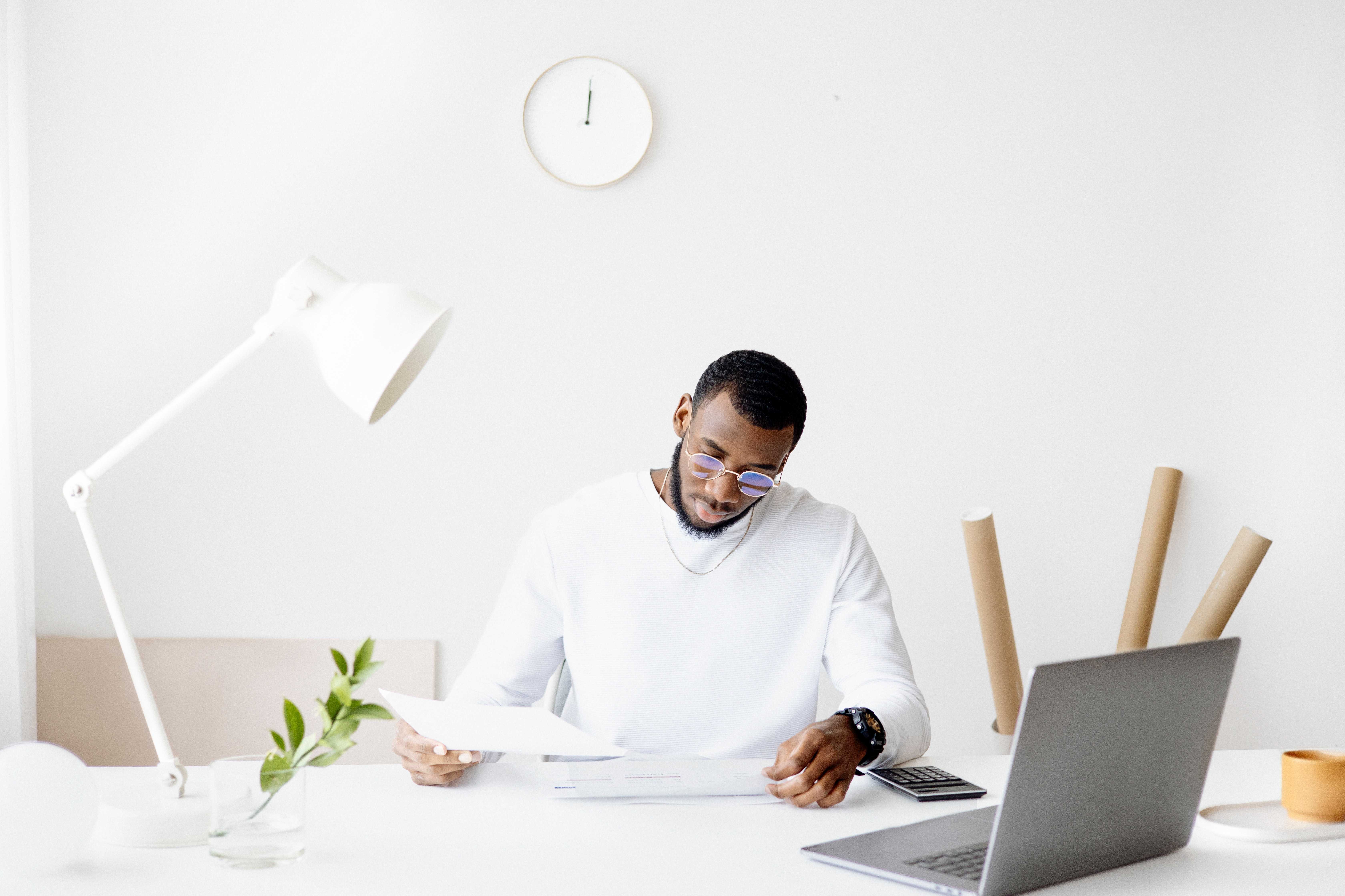 person-smartphone-desk-laptop